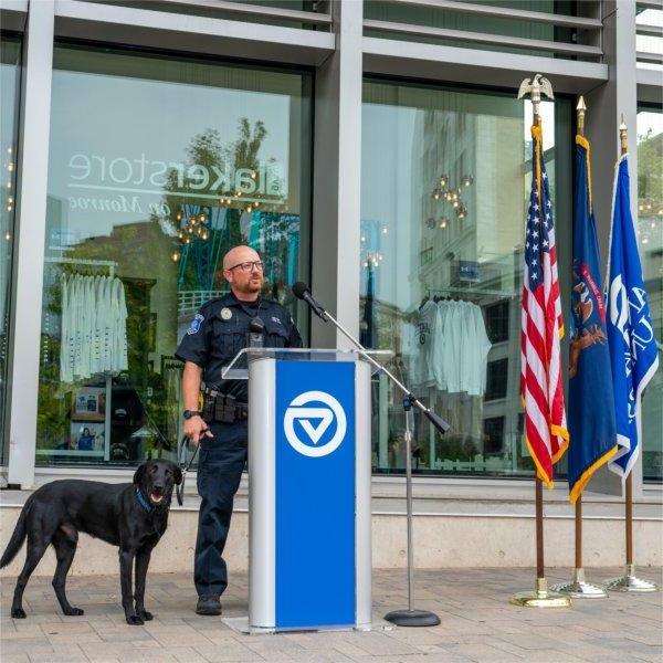 Grand Valley Police Department Officer Paul Weaver with Scout, the new black Labrador K9 police dog, during a press conference.